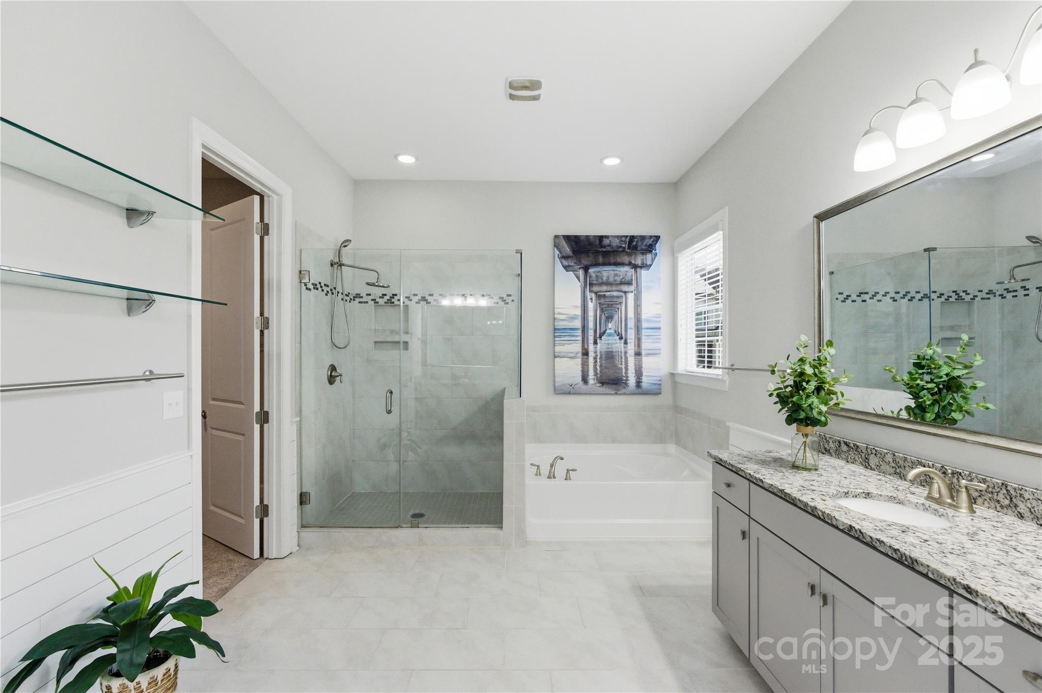 194 Forsythia Lane Tega Cay, SC 29708 - Photo 23 of 31 a spacious bathroom with a granite countertop tub sink a mirror a shower and vanity
