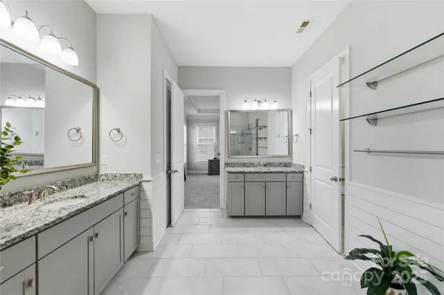 a large kitchen with a granite countertop sink and a refrigerator