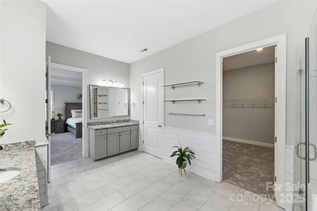 a large white kitchen with cabinets and stainless steel appliances