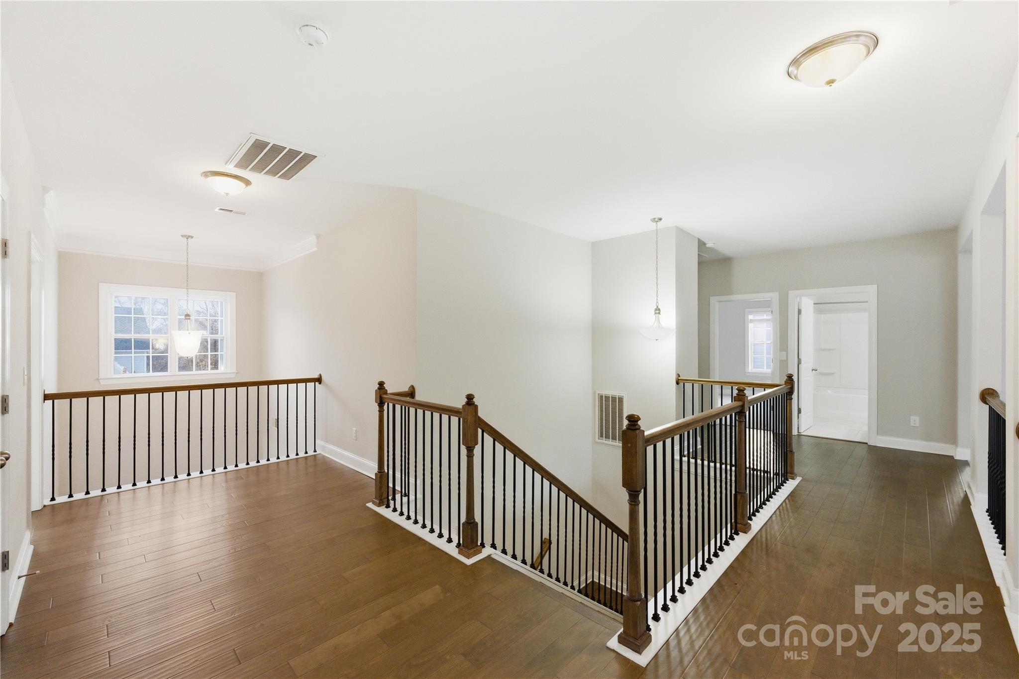194 Forsythia Lane Tega Cay, SC 29708 - Photo 26 of 31 a view of a hallway with wooden floor and windows