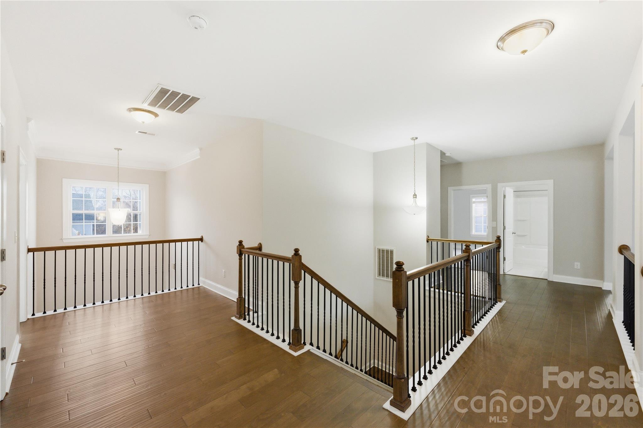 194 Forsythia Lane Tega Cay, SC 29708 - Photo 26 of 36 a view of a hallway with wooden floor and stairs