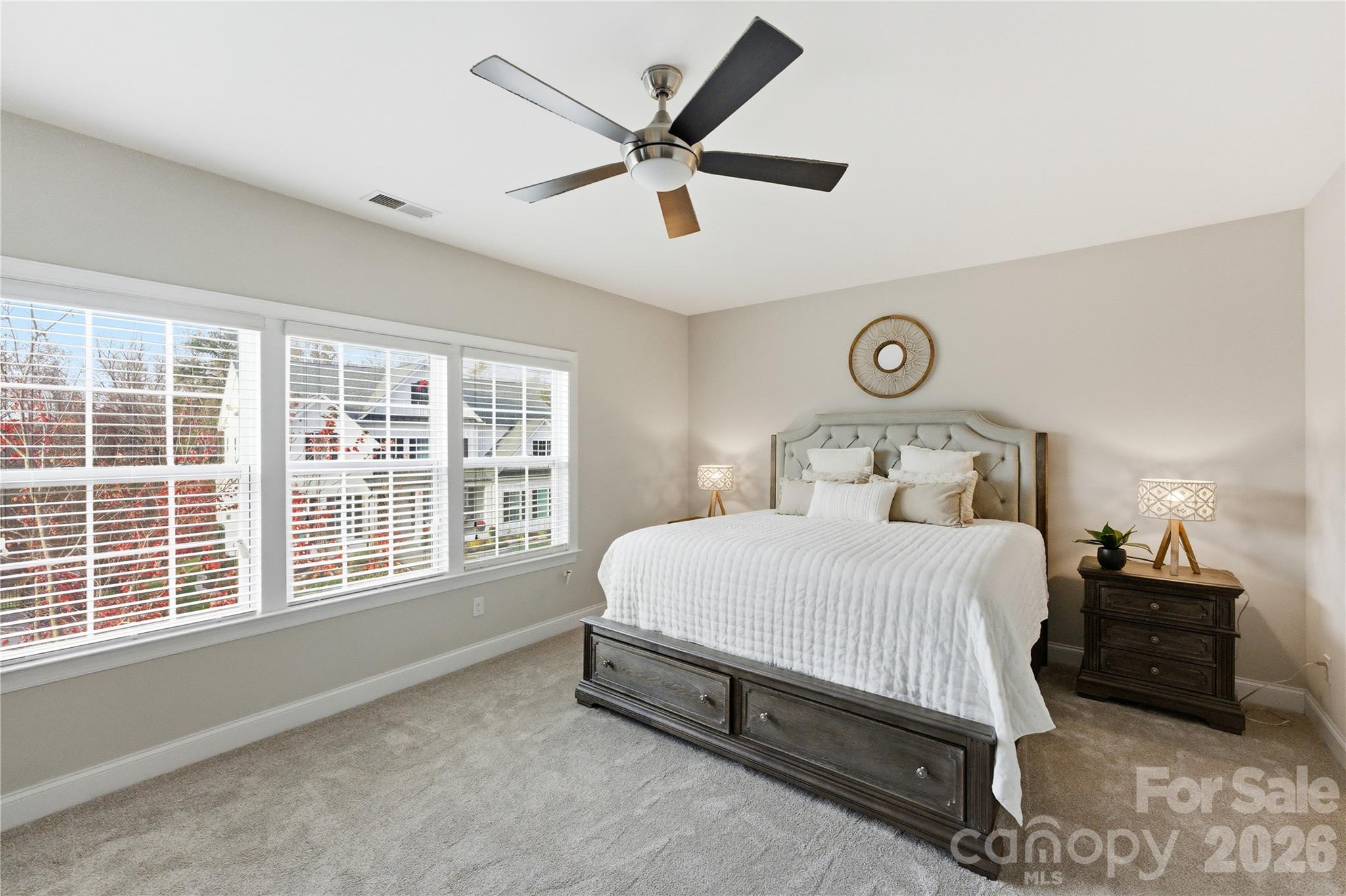 194 Forsythia Lane Tega Cay, SC 29708 - Photo 27 of 36 a bedroom with a bed and a large window