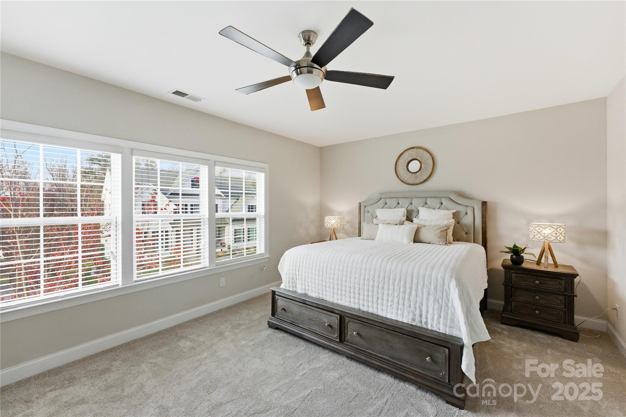 194 Forsythia Lane Tega Cay, SC 29708 - Photo 27 of 31 a bedroom with a bed and a large window