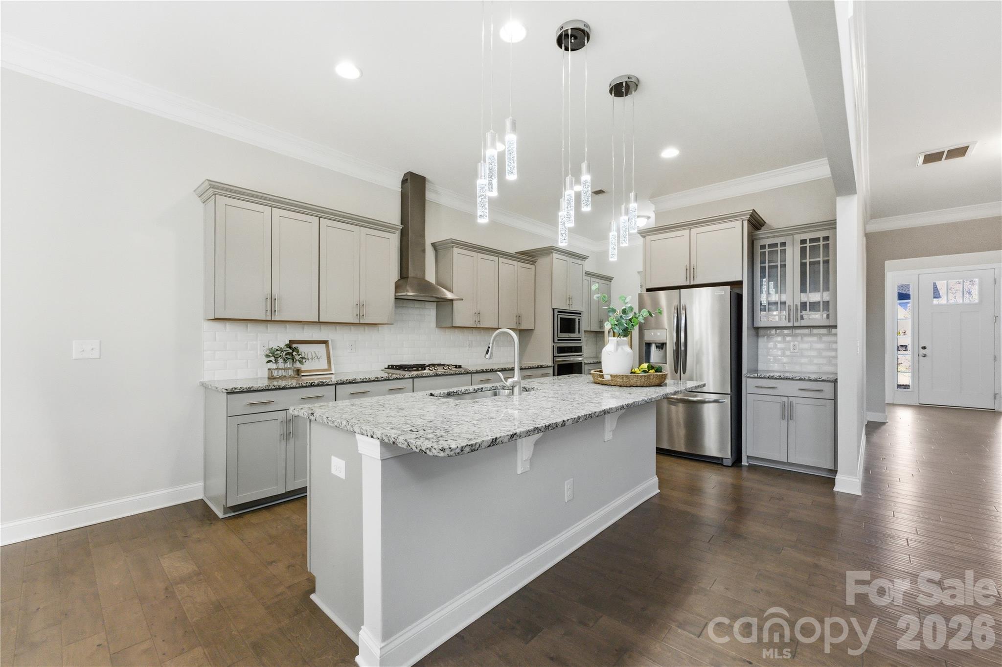 194 Forsythia Lane Tega Cay, SC 29708 - Photo 9 of 36 a large kitchen with stainless steel appliances kitchen island granite countertop a refrigerator and a stove top oven