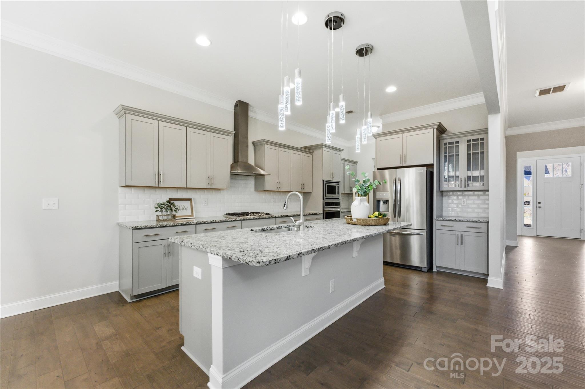 194 Forsythia Lane Tega Cay, SC 29708 - Photo 9 of 31 a large kitchen with stainless steel appliances kitchen island granite countertop a refrigerator and a stove top oven