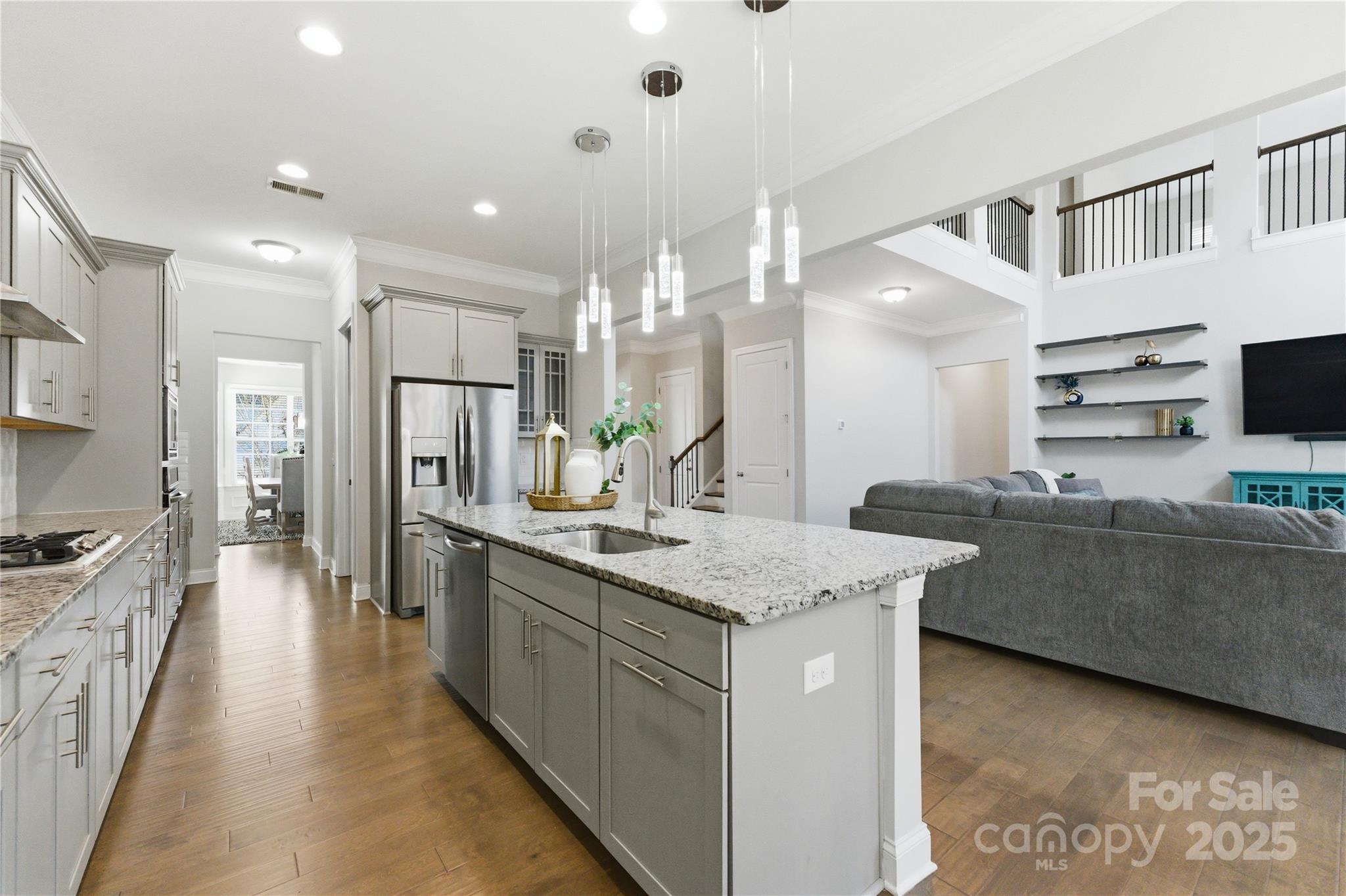 194 Forsythia Lane Tega Cay, SC 29708 - Photo 10 of 31 a large kitchen with kitchen island a sink a stove a refrigerator and a cabinets