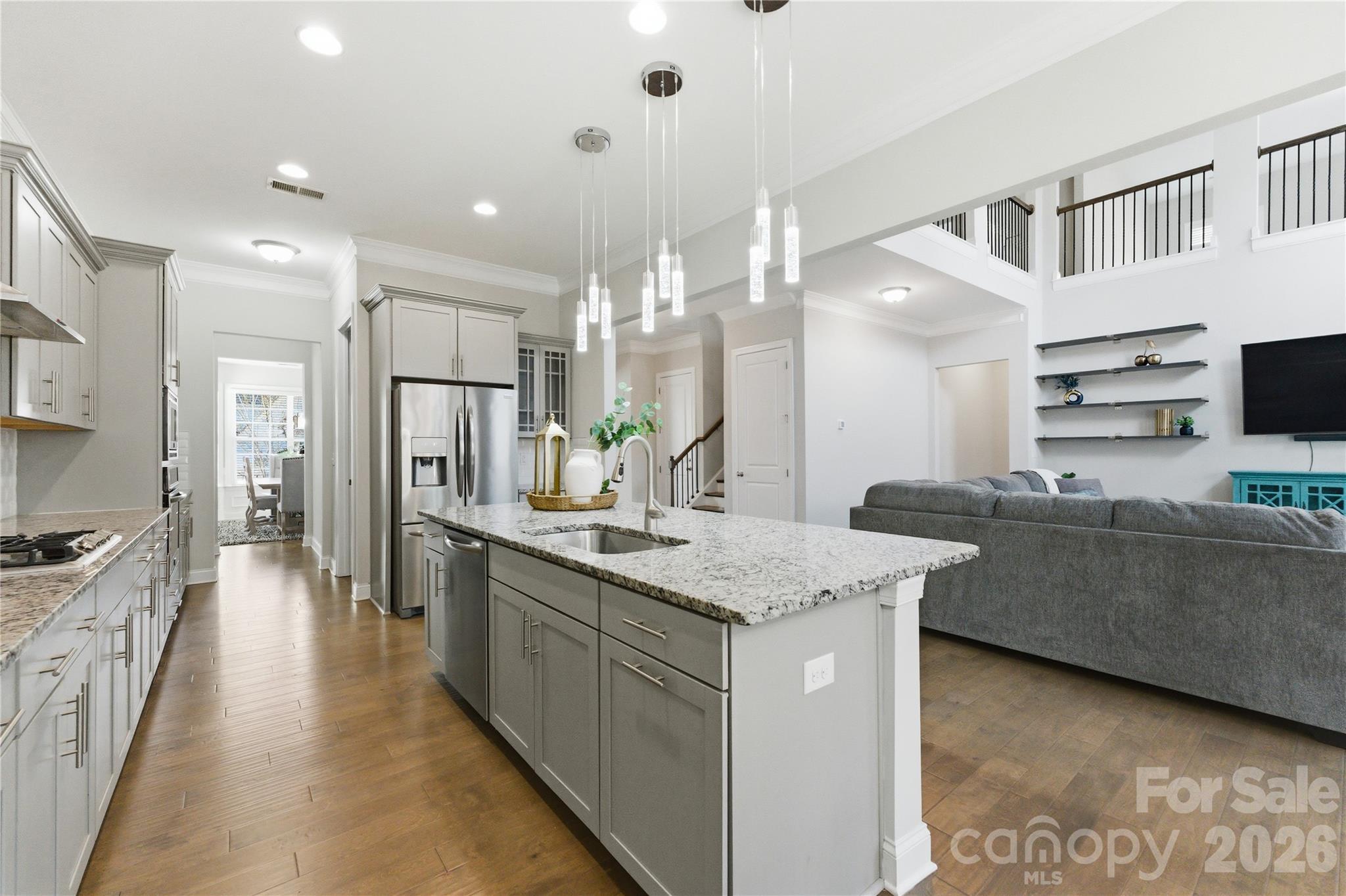 194 Forsythia Lane Tega Cay, SC 29708 - Photo 10 of 36 a large kitchen with kitchen island a sink a stove a refrigerator and a cabinets
