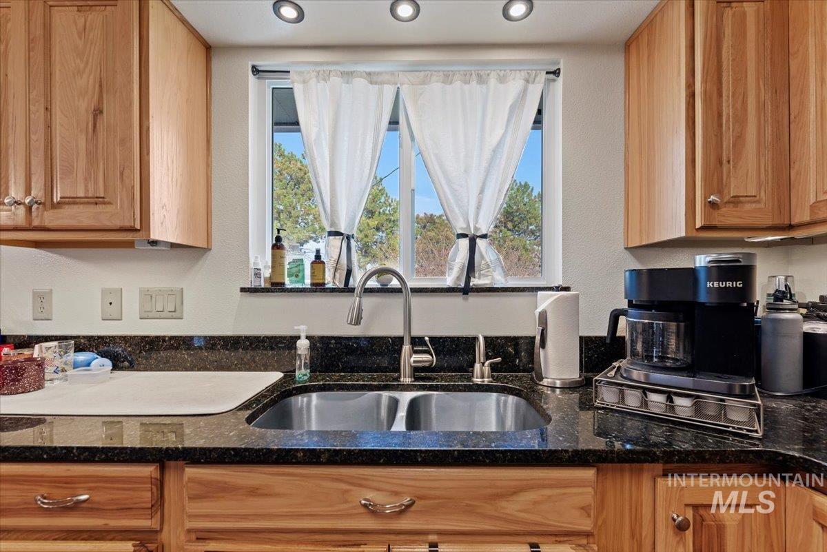 11650 Columbia Road Boise, ID 83709 - Photo 11 of 32 Kitchen featuring dark stone countertops and healthy amount of natural light