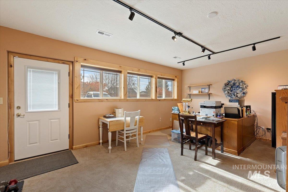 11650 Columbia Road Boise, ID 83709 - Photo 19 of 32 Home office with track lighting, light colored carpet, and a textured ceiling