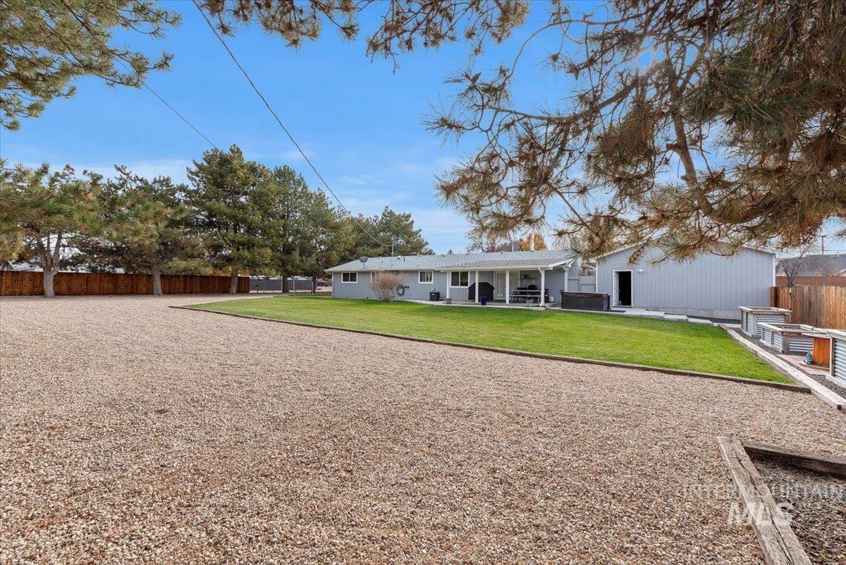 11650 Columbia Road Boise, ID 83709 - Photo 23 of 32 Back of house featuring a fenced backyard and a patio area