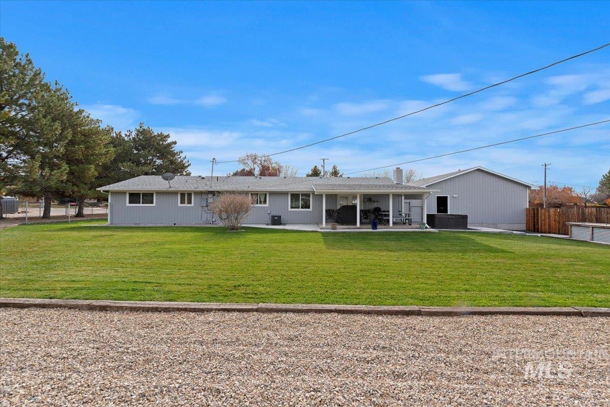 11650 Columbia Road Boise, ID 83709 - Photo 24 of 32 Rear view of property featuring a patio and a hot tub
