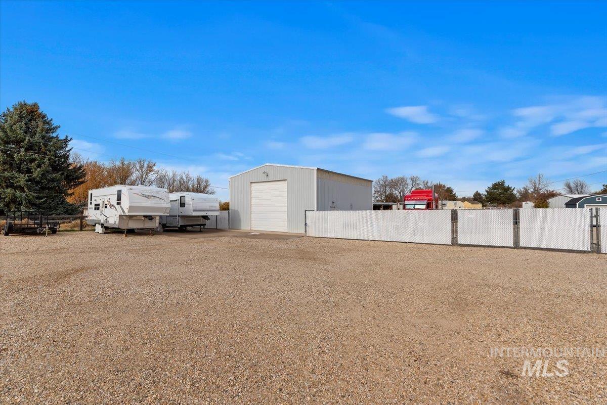 11650 Columbia Road Boise, ID 83709 - Photo 30 of 32 View of yard featuring an outbuilding and a detached garage