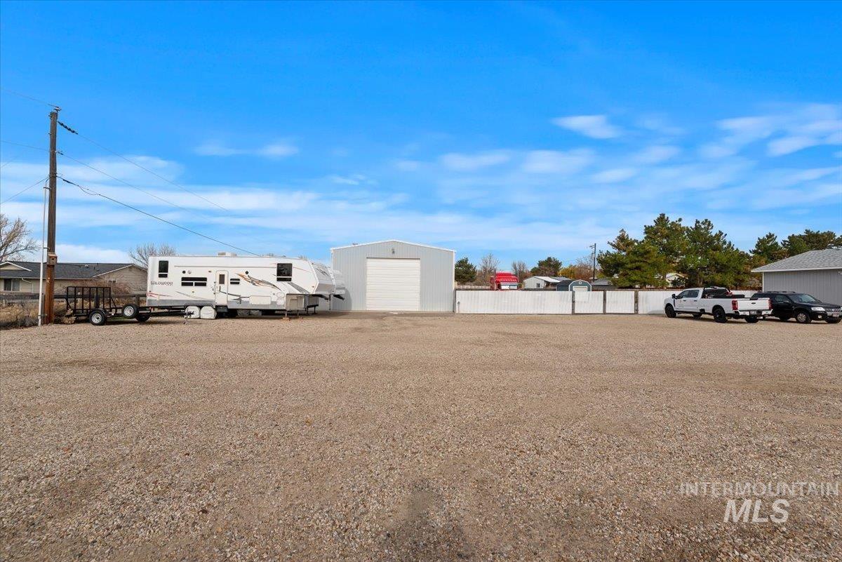 11650 Columbia Road Boise, ID 83709 - Photo 31 of 32 View of yard featuring an outdoor structure and a detached garage
