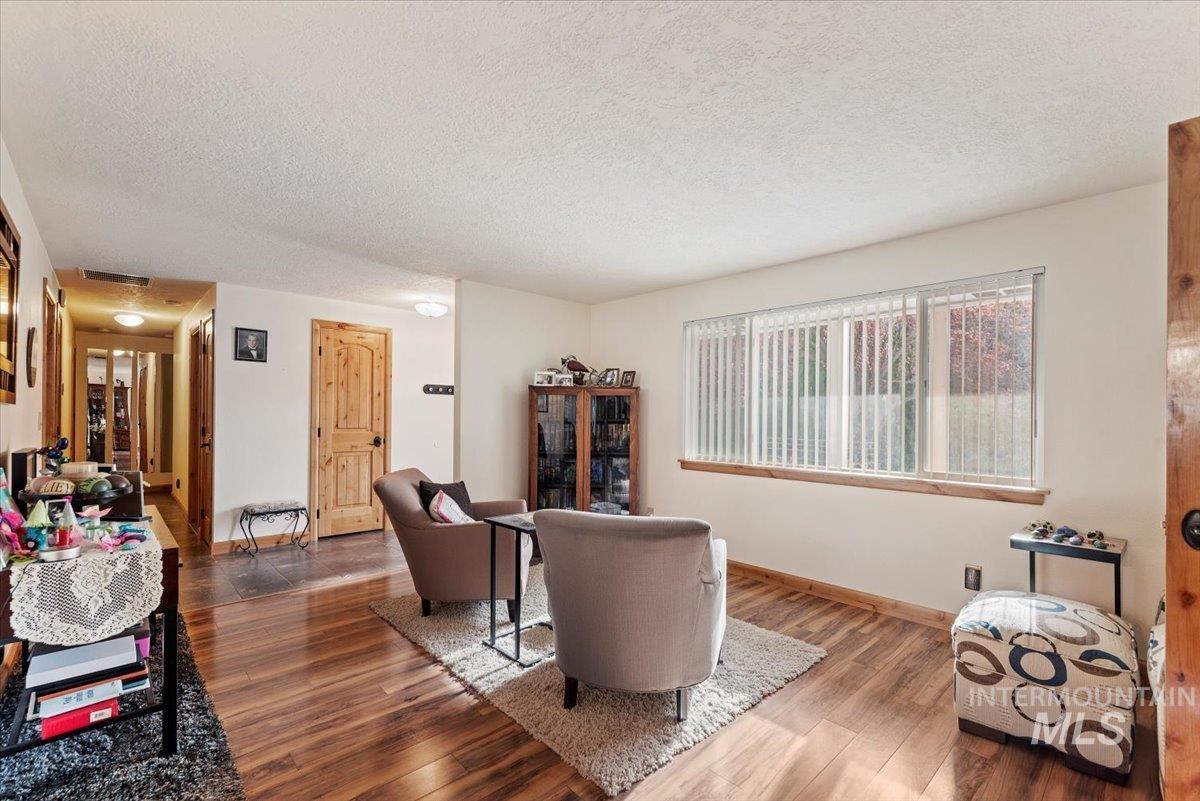 11650 Columbia Road Boise, ID 83709 - Photo 5 of 32 Living area with wood finished floors and a textured ceiling
