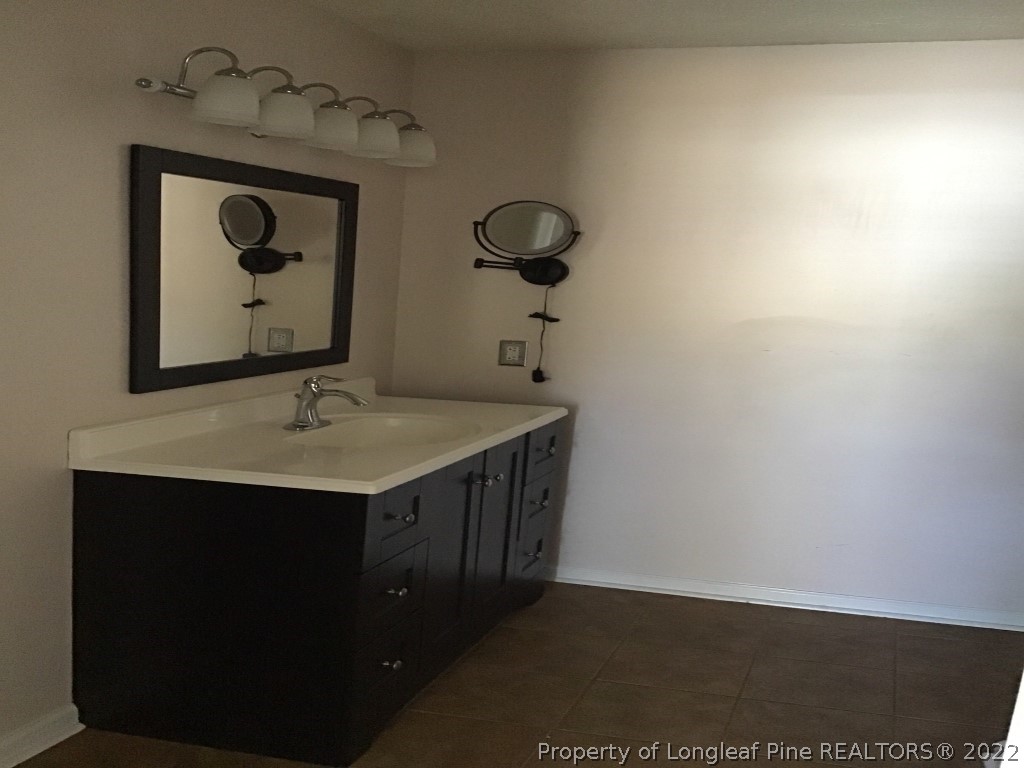 1913-4 Sardonyx Road Fayetteville, NC 28303 - Photo 11 of 12 a bathroom with a sink and a mirror
