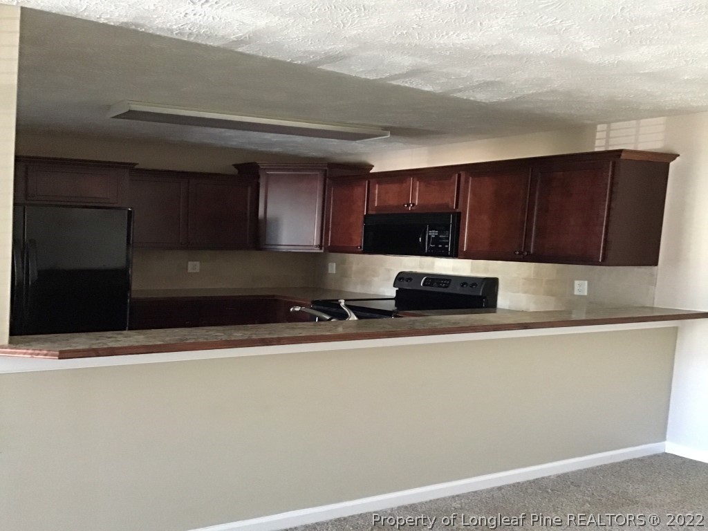 1913-4 Sardonyx Road Fayetteville, NC 28303 - Photo 4 of 12 a kitchen with stainless steel appliances a sink a stove and a refrigerator