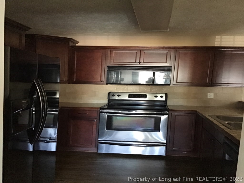 1913-4 Sardonyx Road Fayetteville, NC 28303 - Photo 5 of 12 a kitchen with a stove and a microwave