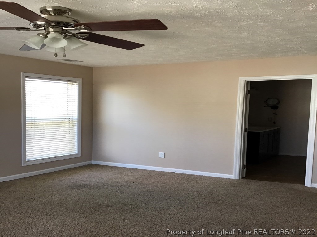 1913-4 Sardonyx Road Fayetteville, NC 28303 - Photo 10 of 12 an empty room with windows and ceiling fan