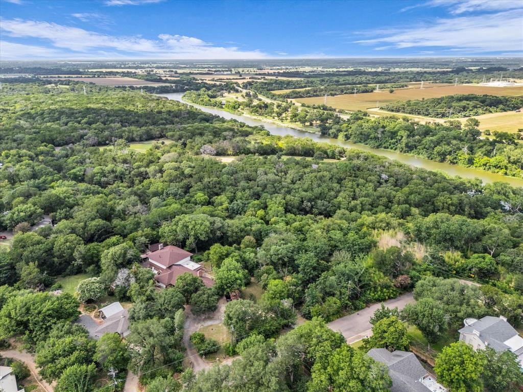 421 Rice Avenue Waco, TX 76708 - Photo 18 of 22 Expansive property featuring dense tree coverage, a natural water body, and surrounding agricultural land
