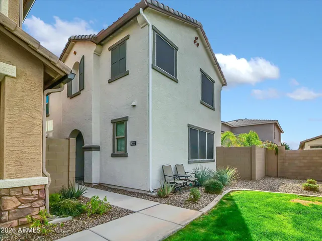 a front view of a house with garden
