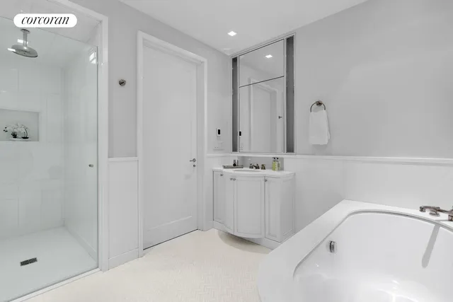 a bathroom with a granite countertop toilet sink and mirror