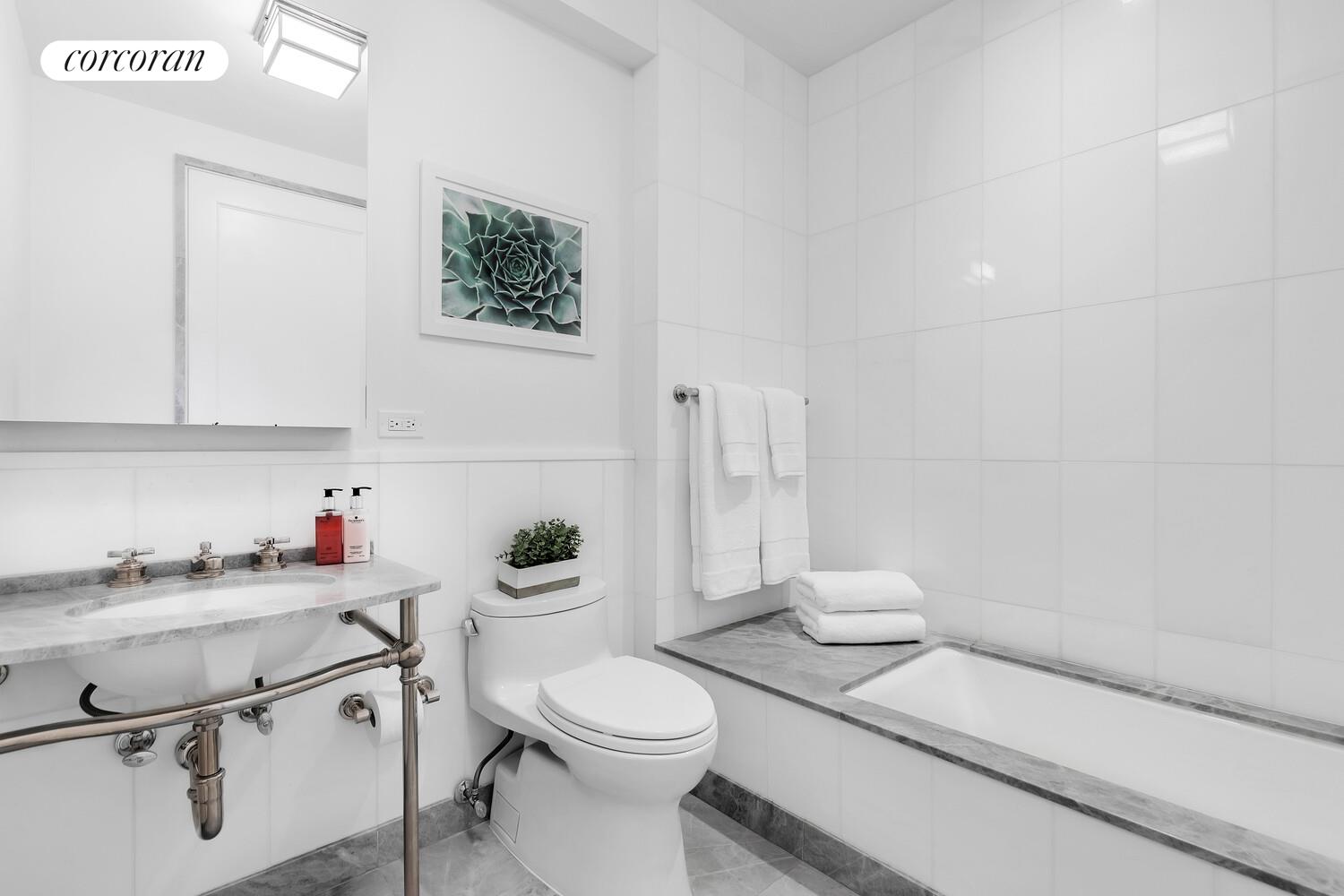 40 East 72nd Street, Unit MAIS Manhattan, NY 10021 - Photo 14 of 17 a bathroom with a granite countertop toilet sink and mirror