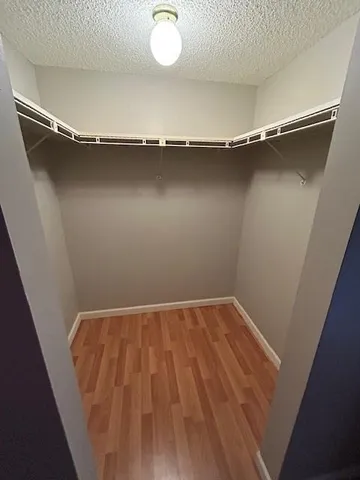 a view of a room with wooden floor and air conditioner