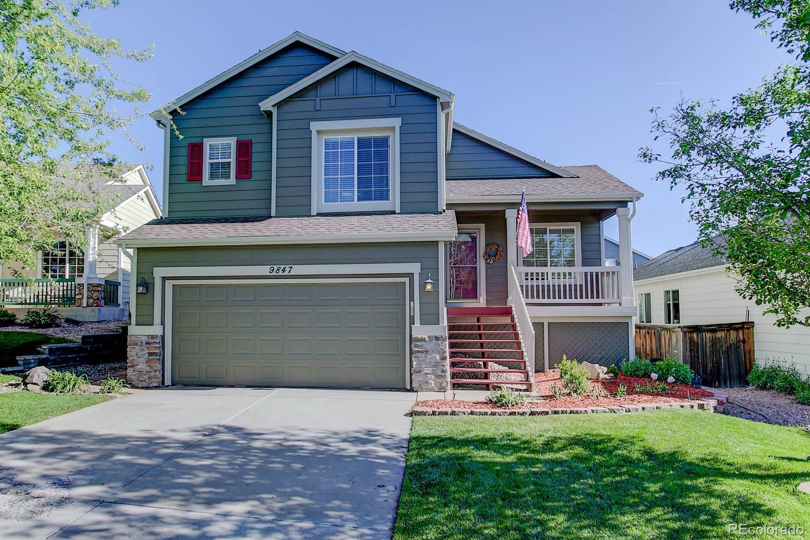 9847 Sydney Lane Highlands Ranch, CO 80130 - Photo 1 of 32 a front view of a house with a yard and garage