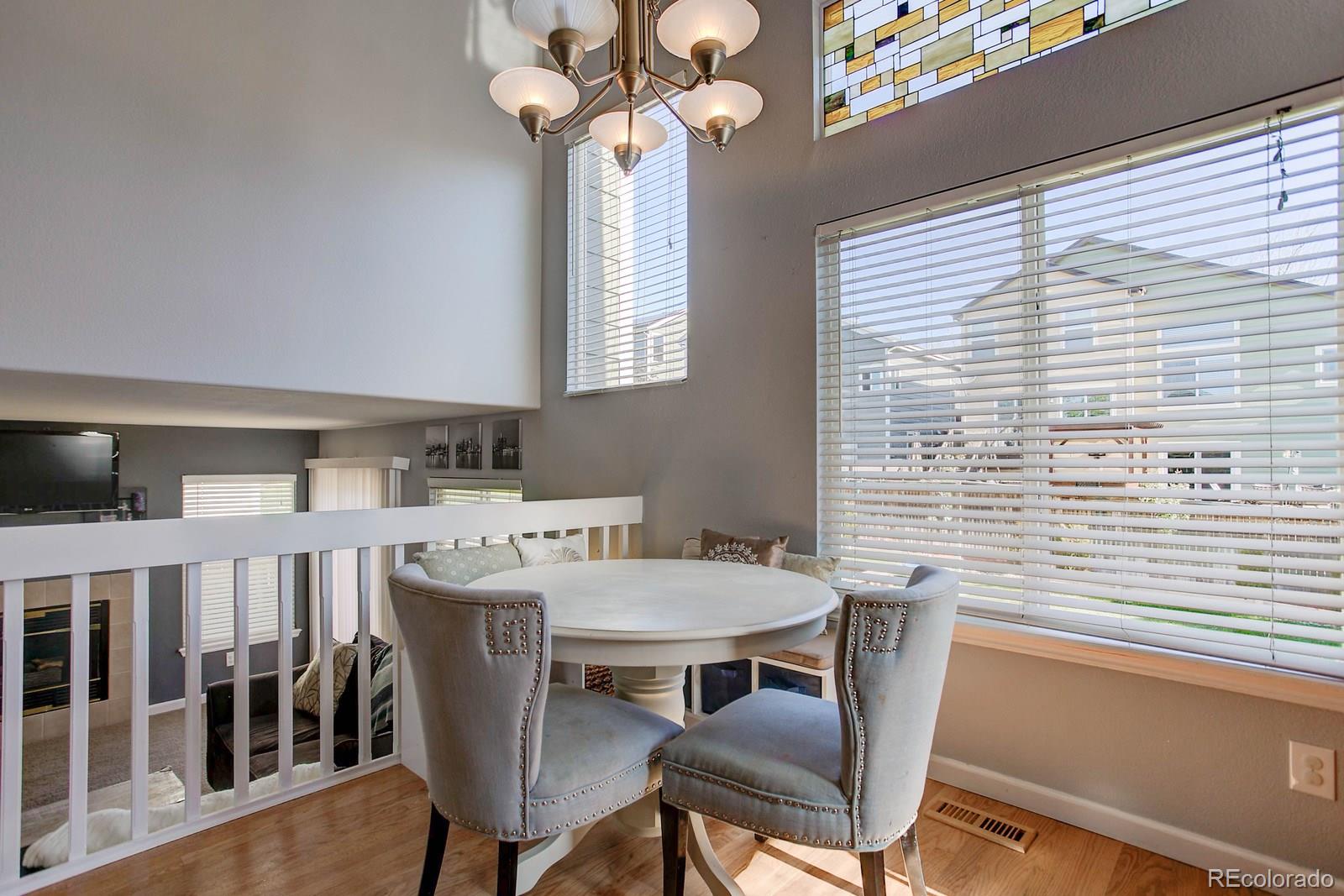 9847 Sydney Lane Highlands Ranch, CO 80130 - Photo 11 of 32 a view of a dining room with furniture window and wooden floor