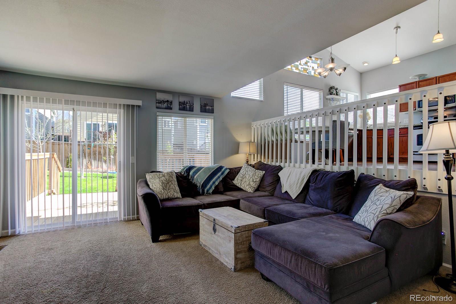 9847 Sydney Lane Highlands Ranch, CO 80130 - Photo 13 of 32 a living room with furniture and a large window