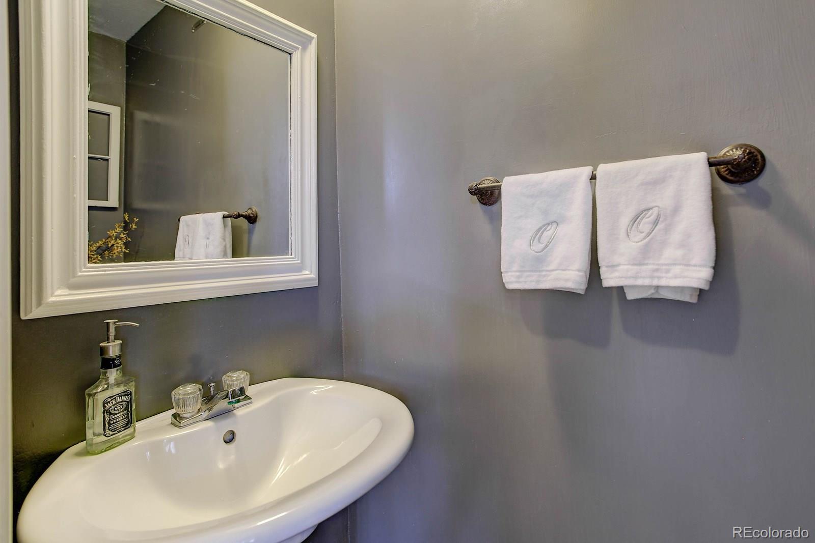 9847 Sydney Lane Highlands Ranch, CO 80130 - Photo 15 of 32 a bathroom with a sink and mirror