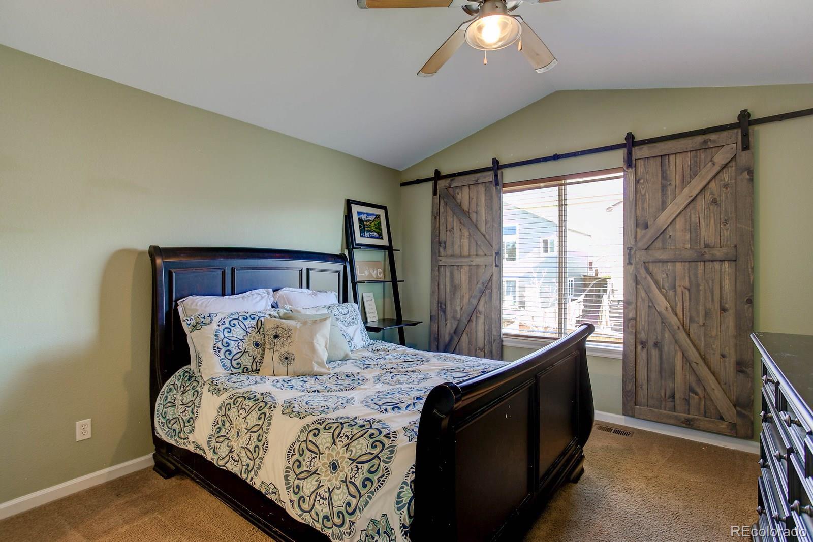 9847 Sydney Lane Highlands Ranch, CO 80130 - Photo 17 of 32 a bedroom with a bed and wooden floor