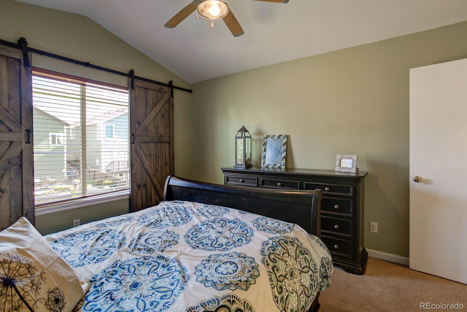 9847 Sydney Lane Highlands Ranch, CO 80130 - Photo 19 of 32 a bedroom with a bed and a window
