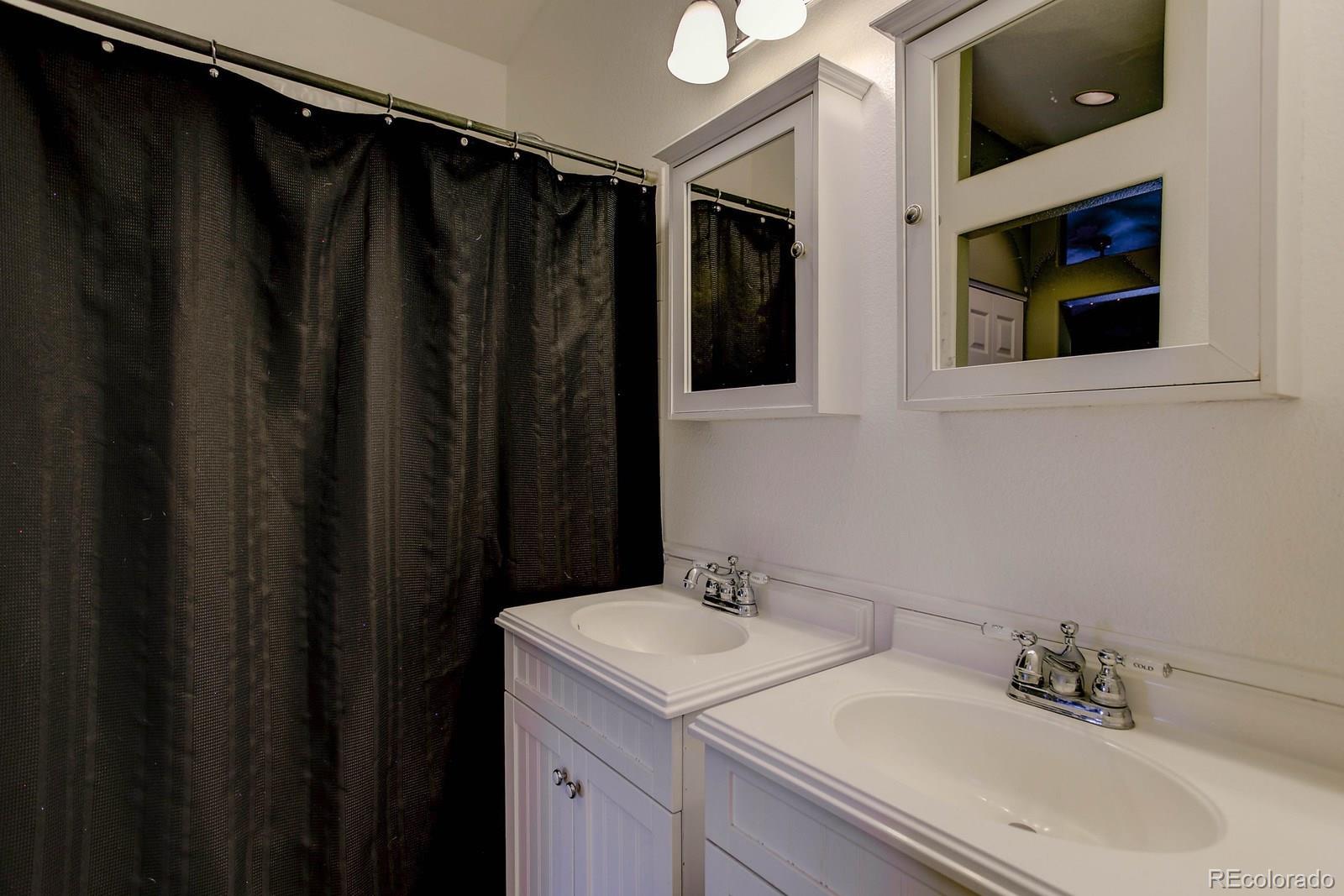 9847 Sydney Lane Highlands Ranch, CO 80130 - Photo 20 of 32 a bathroom with a sink and mirror