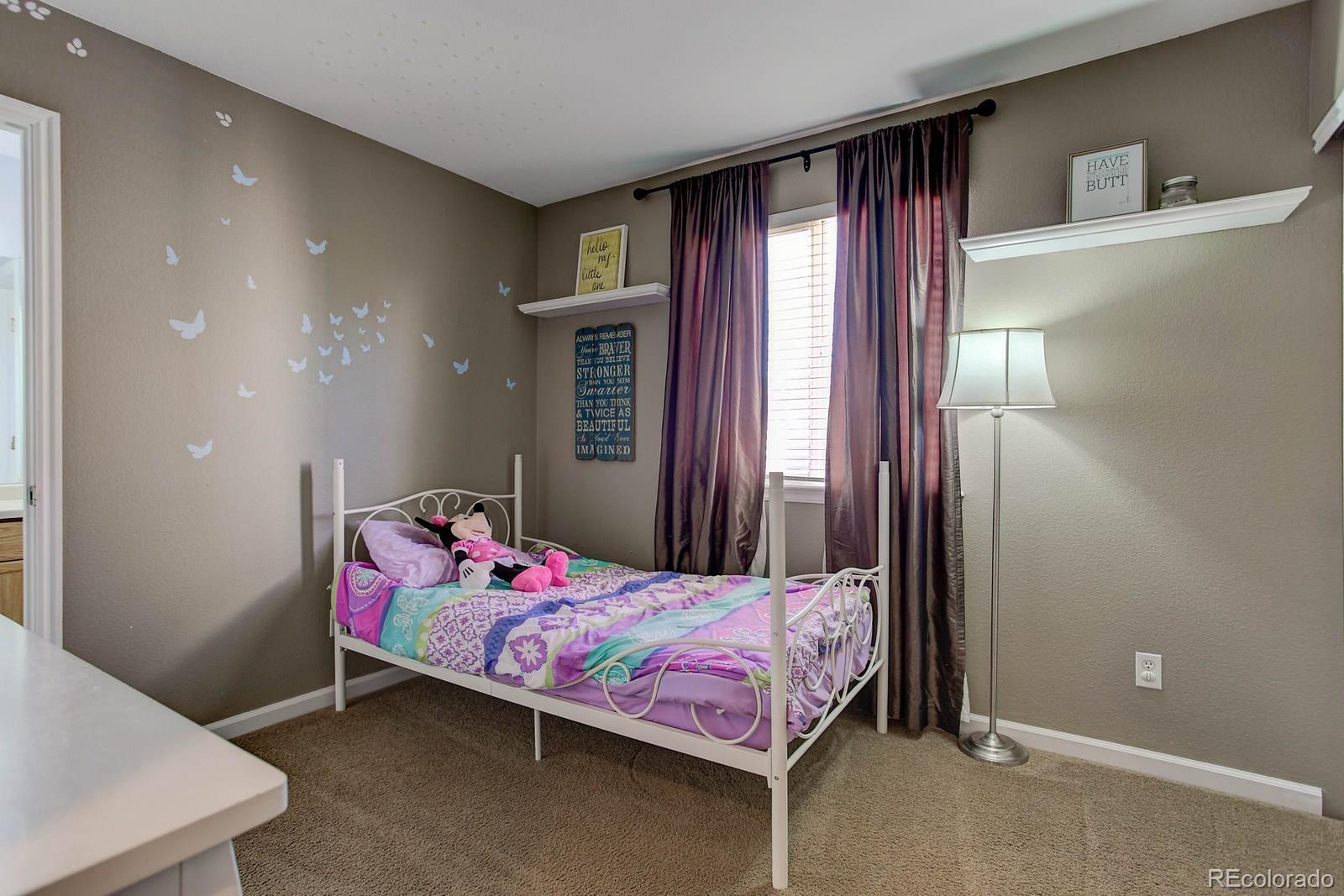 9847 Sydney Lane Highlands Ranch, CO 80130 - Photo 21 of 32 a bedroom with a bed and window