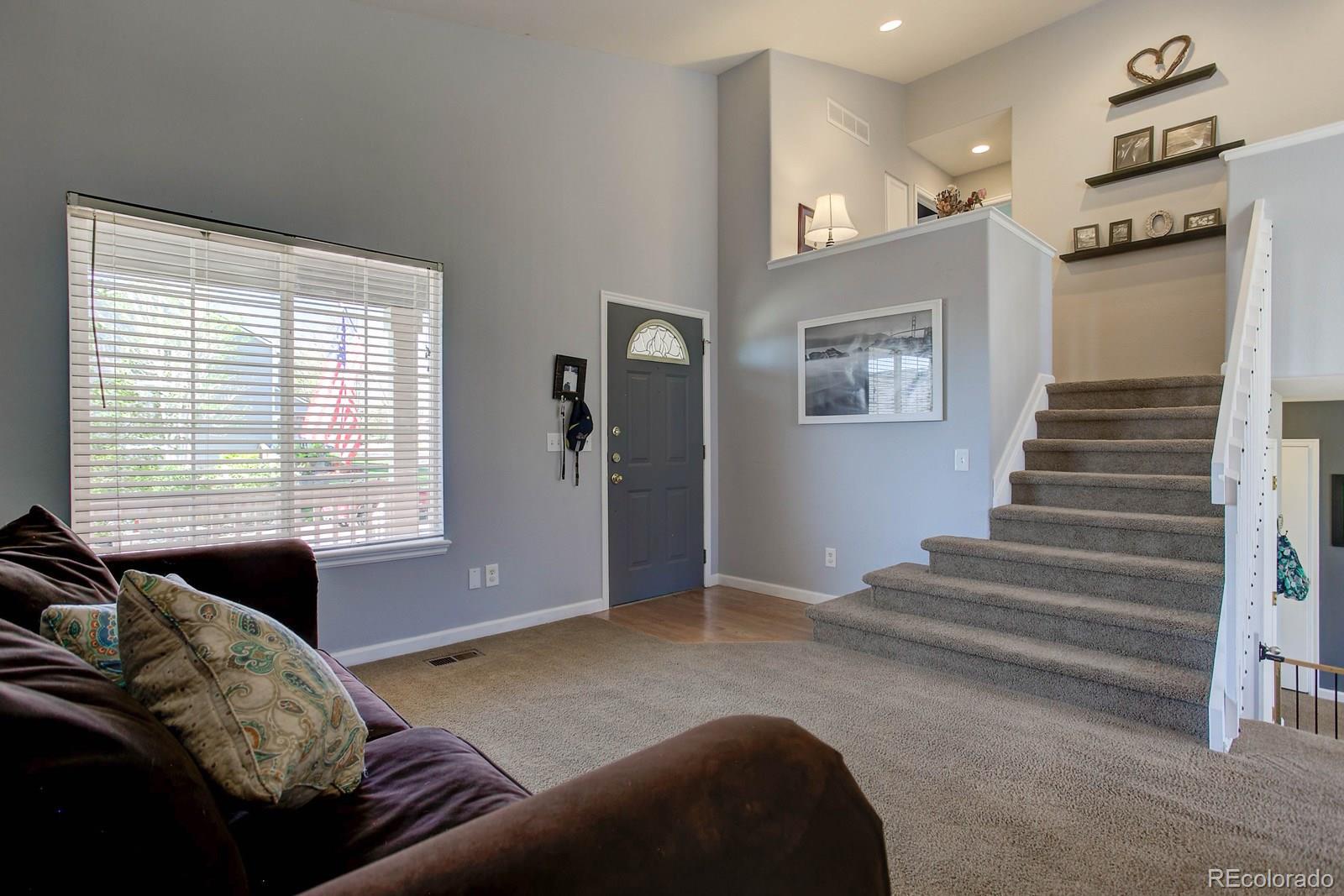9847 Sydney Lane Highlands Ranch, CO 80130 - Photo 5 of 32 a living room with furniture and a window