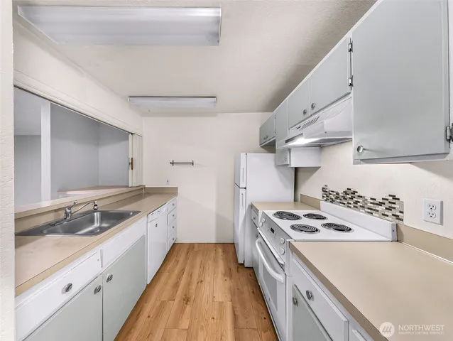 a kitchen with stainless steel appliances granite countertop a stove and a sink