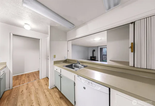 a kitchen that has a sink and a stove in it
