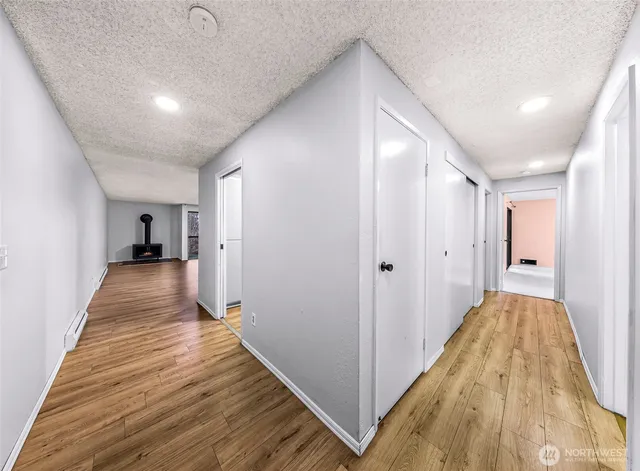 a view of a hallway with wooden floor and staircase