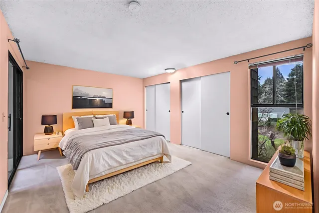 a bedroom with a large bed and a window