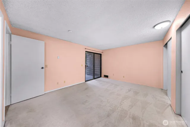 a bathroom with a granite countertop sink a toilet and a mirror