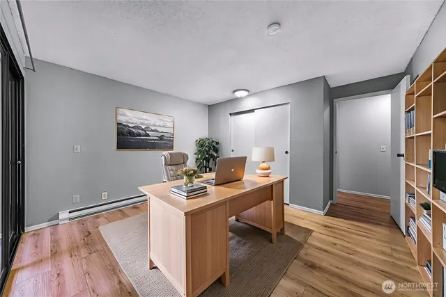 a view of empty room with wooden floor