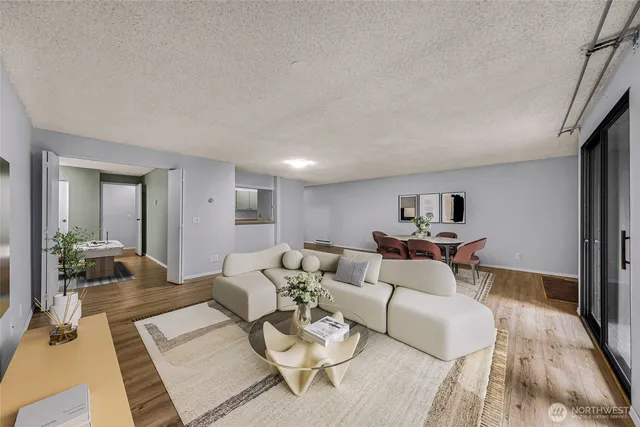 a living room with furniture and a wooden floor