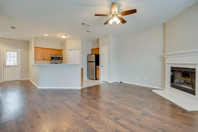 a view of a kitchen with a sink a kitchen counter top and a fireplace