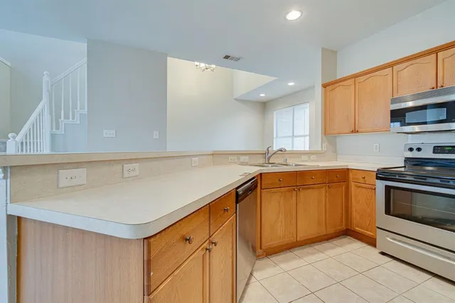 a kitchen with stainless steel appliances granite countertop a sink and a stove