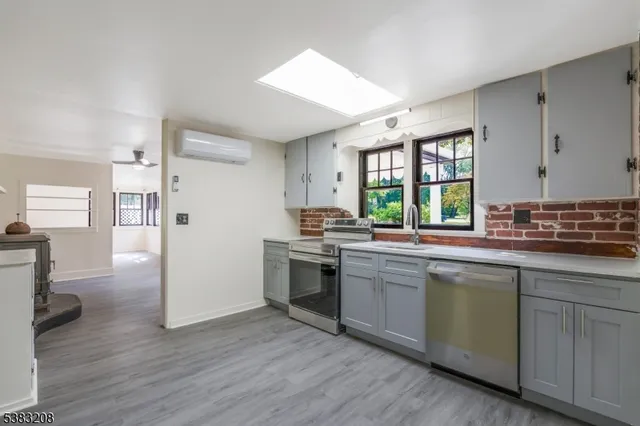 a kitchen with sink cabinets and wooden floor