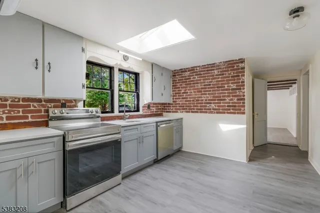 a kitchen with a sink stove top oven and cabinets