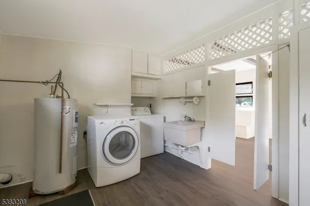 a utility room with sink dryer and washer