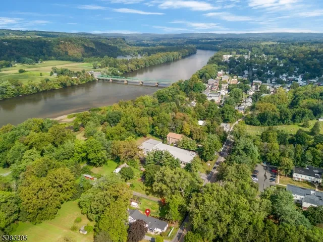 an aerial view of residential houses with outdoor space and lake view