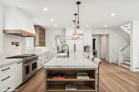 a kitchen with a stove a refrigerator and a table